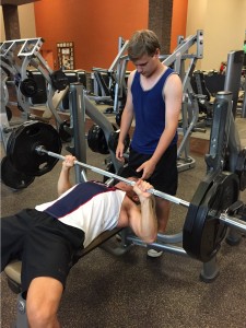 Joe benches 225 lbs. while his son Stephen spots him on the bench